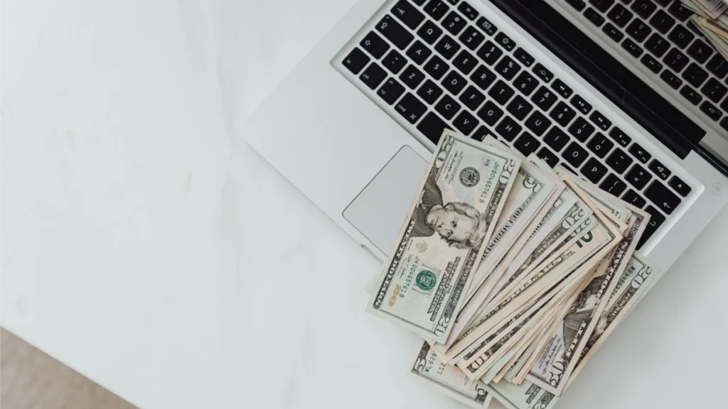 money in dollars on a laptop